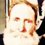 Portrait of an elderly man with a white beard and red hair.