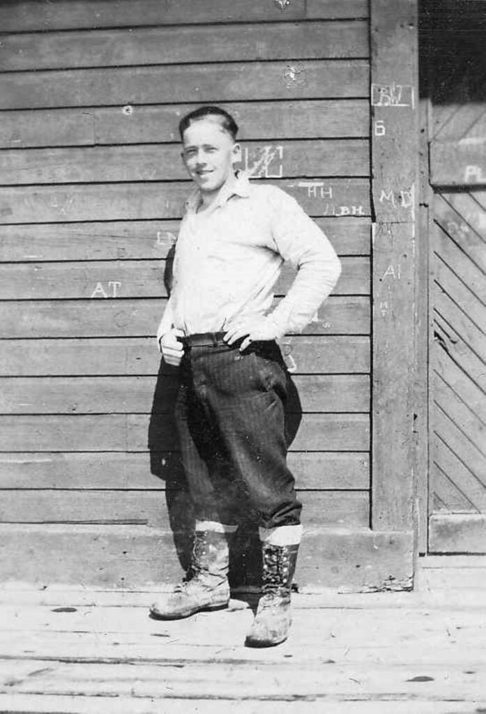 Gentleman standing in breeches and furlined work boots.