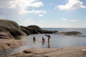 People in water Surrounded by rocks.
