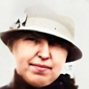 A woean in a light coloured hat and dark coat. head only captured.