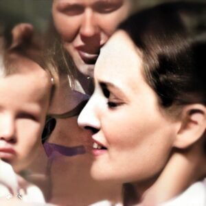 A picture of 2 women and one is holding a baby.