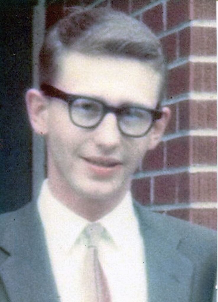 A portrait of a man in a shirt and tie.